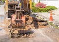 Excavator working on the Repair of pipe water and sewerage on road Royalty Free Stock Photo