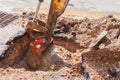 Excavator working on the Repair of pipe water and sewerage on road Royalty Free Stock Photo