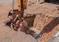 Excavator working the Repair of pipe water sewerage on road Royalty Free Stock Photo