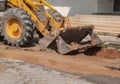 Excavator working the Repair of pipe water sewerage on road Royalty Free Stock Photo