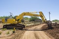 Excavator working on road. Royalty Free Stock Photo