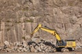 Excavator working on a stone quarry. Geological excavation equipment Royalty Free Stock Photo