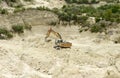 Excavator works in the quarry for quarrying sand Royalty Free Stock Photo