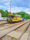 Excavator yellow on the railway track of the Czech Republic. Zadni Treban.