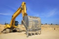 Excavator yellow vehicle on sand quarry