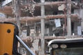 Excavators on a demolition site with old demolished building in the background. Old building being demolished to make room for new Royalty Free Stock Photo