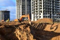 Excavators and dozers digs the ground for the foundation and construction of a new building.