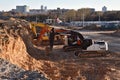 Excavators HIDROMEK, HITACHI and JCB on earthworks at construction site. Backhoe on foundation work and road construction. Tower Royalty Free Stock Photo