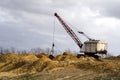 Excavators in the red clay quarry