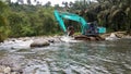 Excavators are working in the middle of the river.