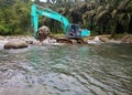 Excavators are working in the middle of the river. Royalty Free Stock Photo