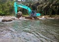 Excavators are working in the middle of the river.