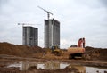 Excavtor and bulldozer digg ground at construction site for the construction of the road