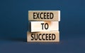 Exceed to succeed symbol. Concept words Exceed to succeed on beautiful wooden blocks. Beautiful grey table grey background.