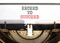 Exceed to succeed symbol. Concept words Exceed to succeed typed on beautiful old retro typewriter. Beautiful white paper