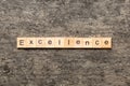 Excellence word written on wood block. Excellence text on cement table for your desing, concept Royalty Free Stock Photo