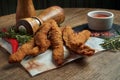 An excellent beer snack is a set of chicken nuggets fries with parchment sauce on a stone tray. Pub food. Close up, selective Royalty Free Stock Photo