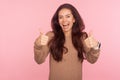 Excellent job, well done! Portrait of joyful awesome young woman with brunette wavy hair showing like gesture