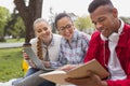 Young fellow sharing his excellent notes with his friends Royalty Free Stock Photo