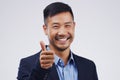 Excellent work. Studio portrait of a handsome young businessman giving a thumbs up against a grey background. Royalty Free Stock Photo