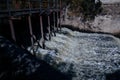 The excess capacity of the dam until spring-way overflows. streams of water, stone walls, a large co Royalty Free Stock Photo