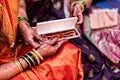 exchange of golden neckles during Indian wedding. Indian bride getting golden necklace from her mother in-law