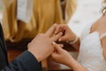 Exchange of rings of bride and groom. Unrecognizable bride puts ring on groom& x27;s finger.Newlyweds. Royalty Free Stock Photo