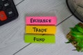 Exchange Trade Fund write on sticky notes isolated on Wooden Table Royalty Free Stock Photo