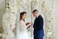 exchange wedding rings.bride and groom in an arch of flowers at wedding ceremony Royalty Free Stock Photo