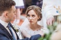 Exchanging wedding vows. bride and groom putting hands on bible and saying wedding oaths in church at wedding matrimony. Royalty Free Stock Photo