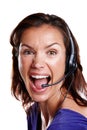 Excited administrator. Close up isolated studio shot of a woman in her 30s wearing a headset and shouting. Royalty Free Stock Photo