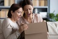 Excited adult mom and daughter open online order