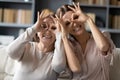 Excited adult mother and daughter make funny gestures posing Royalty Free Stock Photo