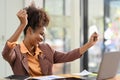 Excited African American businesswoman receive good new on laptop, celebrating business success Royalty Free Stock Photo