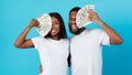 Excited African American couple holding a lot of dollar cash Royalty Free Stock Photo