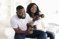 Excited black couple enjoying video game, competing with each other Royalty Free Stock Photo