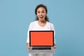 Excited african american doctor woman isolated on blue background. Doctor in medical gown holding laptop pc computer Royalty Free Stock Photo