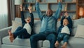 Excited African American happy family father and two siblings boys kids children fans watch TV sport game championship Royalty Free Stock Photo