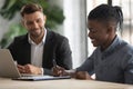 Happy biracial male employee sign paper contract at meeting Royalty Free Stock Photo