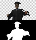 Excited african american male student in graduation robe dancing