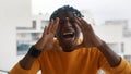 Excited african american man shouting WOW using his hands to amplify his voice