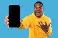 Excited African American Man Showing Phone Screen Over Blue Background Royalty Free Stock Photo