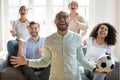 Excited African American man with diverse friends celebrating football win Royalty Free Stock Photo