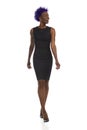 Excited African American Woman In Elegant Black Mini Dress And High Heels Is Walking And Looking To The Side Royalty Free Stock Photo