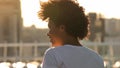 Excited african american woman enjoying morning sun outdoors, joy, back view Royalty Free Stock Photo