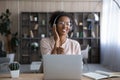 Excited African American woman in headphones enjoying music, using laptop Royalty Free Stock Photo