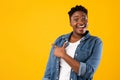 Excited African American Woman Pointing Finger Aside Over Yellow Background