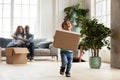 Excited african boy playing with cardboard box on moving day Royalty Free Stock Photo