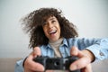 Excited african girl gamer holding joystick controller playing video game. Royalty Free Stock Photo