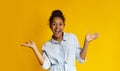 Excited african girl screaming over yellow background Royalty Free Stock Photo